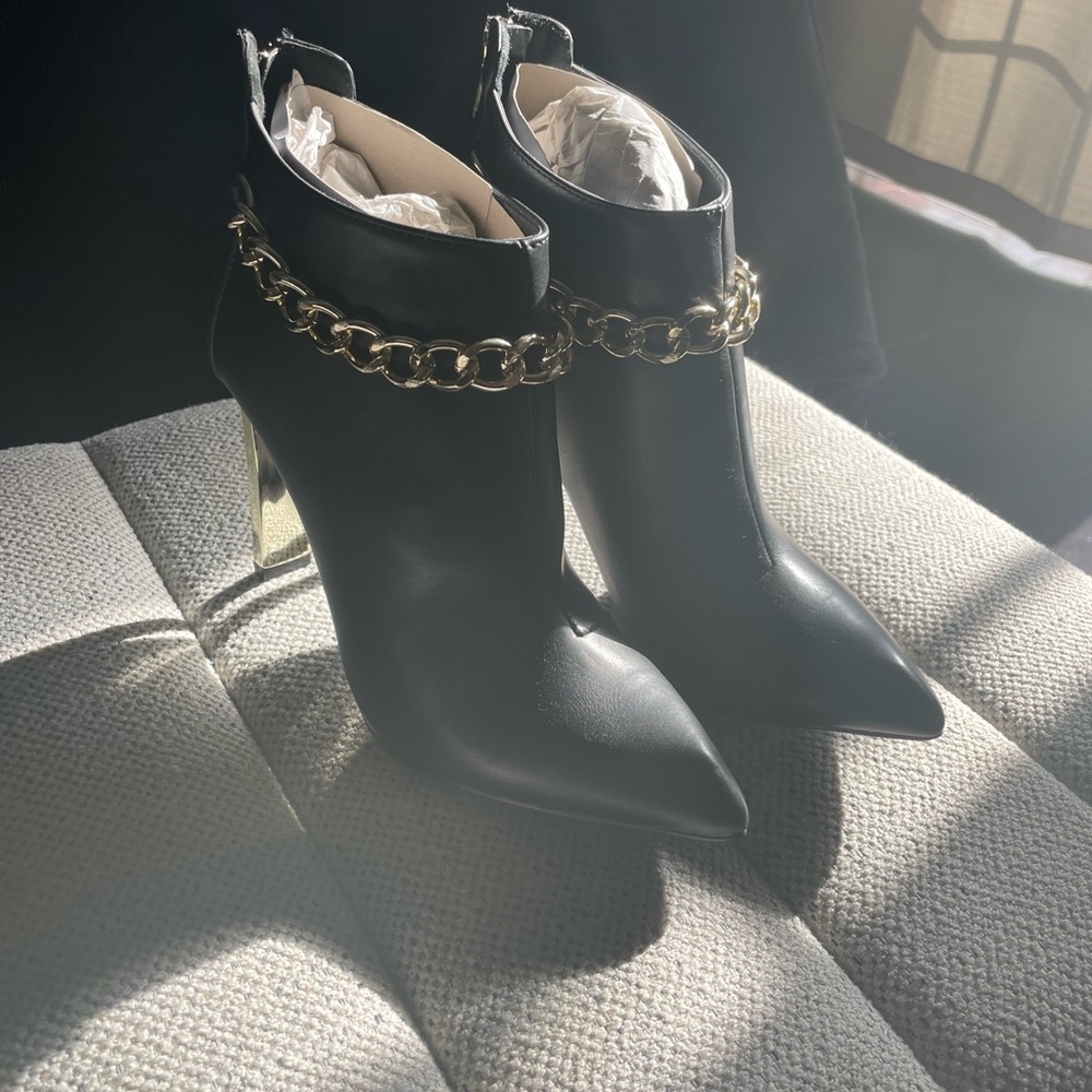 Black and gold ankle high boots with gold chain trim